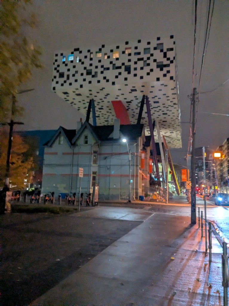 OCAD Sharp Centre for Design at night — table-top building on coloured stilts