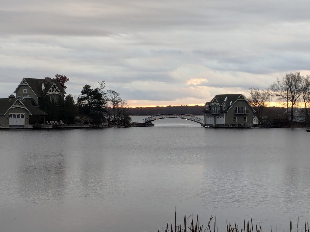 Ontario waterfront — houses linked by a footbridge at dusk